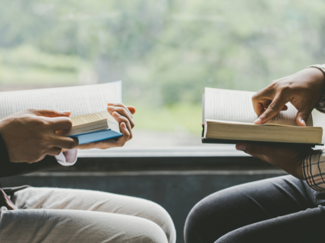 two men studying with books