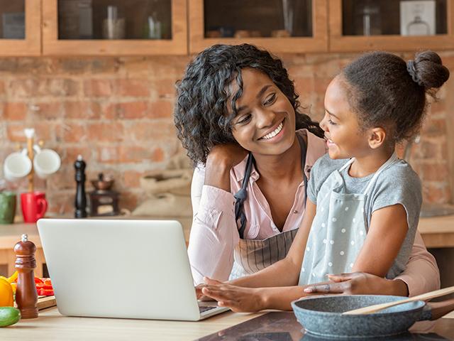 mother and young daughter smiling and chatting