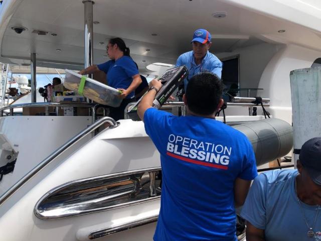 OB teams load a boat with supplies in the Bahamas. 