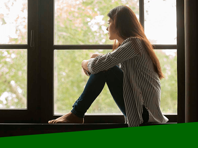 Overcoming Grief young woman looking out a window