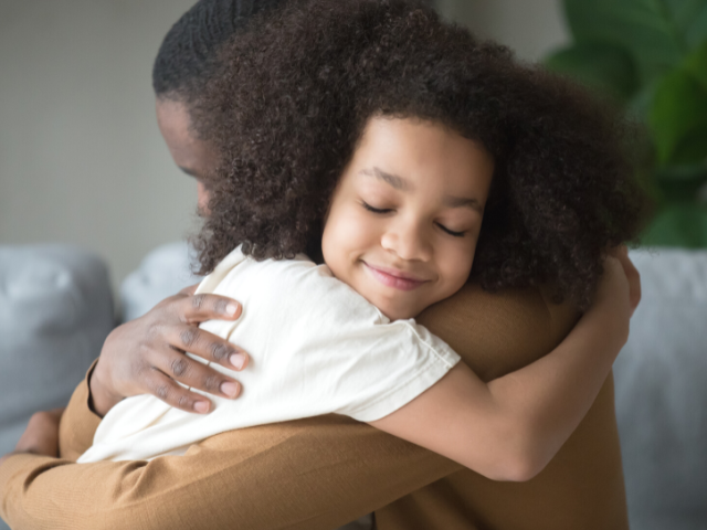 parent and a child hugging close-up