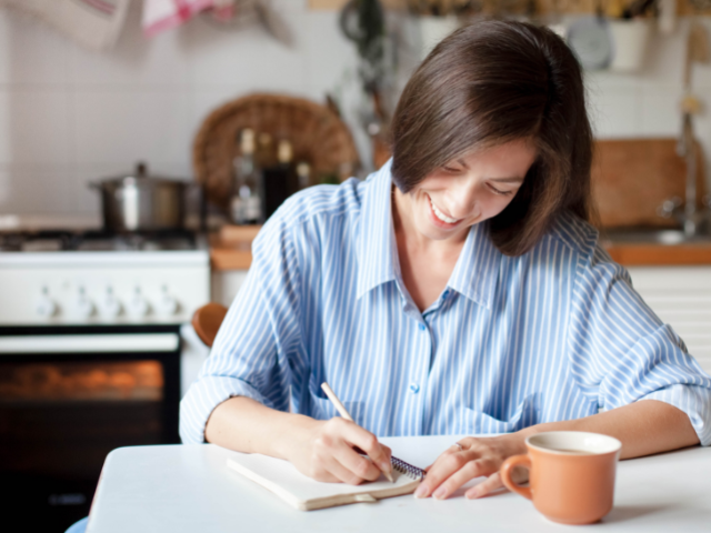 woman writing in a notebook