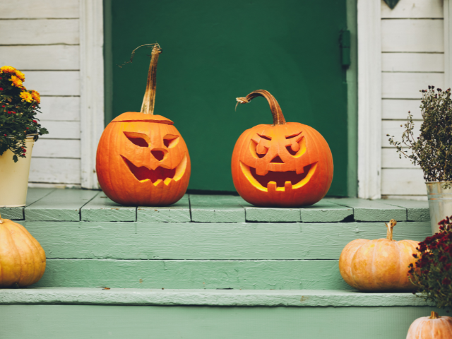 pumpkin jack-o-lanterns on a front porch