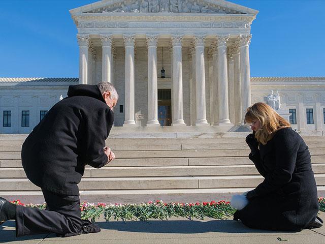 Public lays flowers at US Supreme Court for Tuesday’s ‘Remembering the Unborn Memorial’ (Photo Credit: Patrick Robertson)