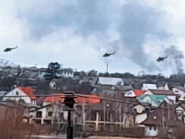 Military helicopters, apparently Russian, fly over outskirts of Kyiv, Ukraine, Feb. 24, 2022 after Russian troops launched their attack on Ukraine. (Ukrainian Police Department Press Service via AP)