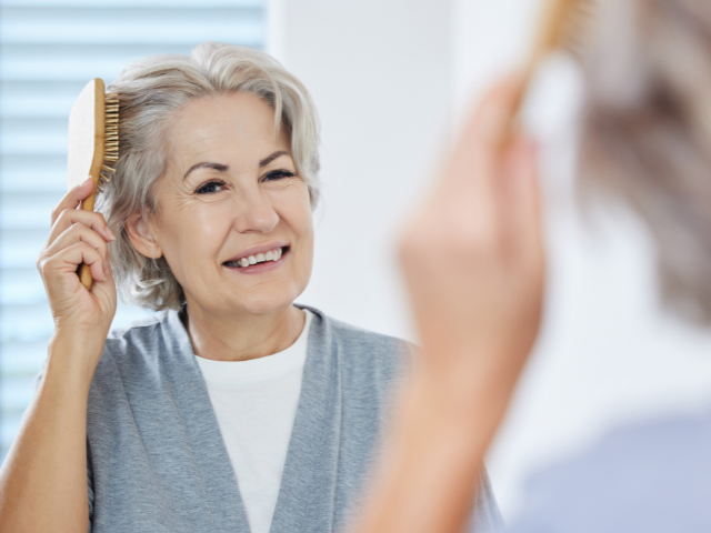 senior woman brushing her hair