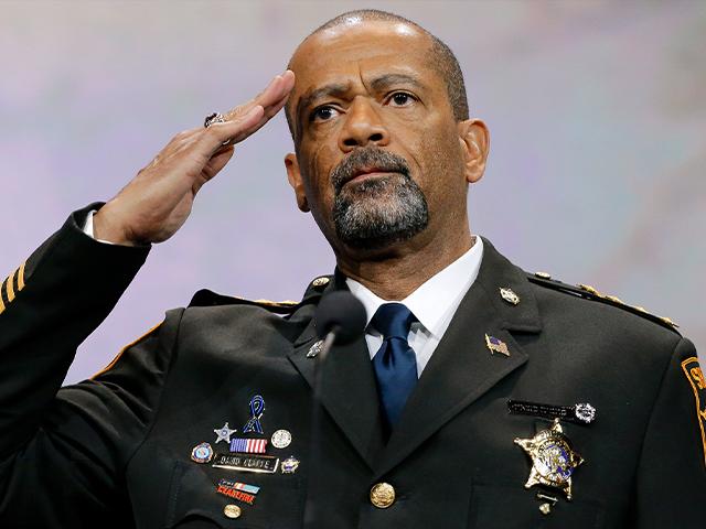 Sheriff David Clarke, Jr., of Milwaukee County, Wisc., salutes the crowd as speaks at the National Rifle Association convention, April 10, 2015, in Nashville, Tenn. (AP Photo/Mark Humphrey)