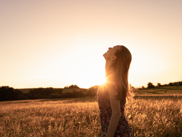 Joyful woman at sunset