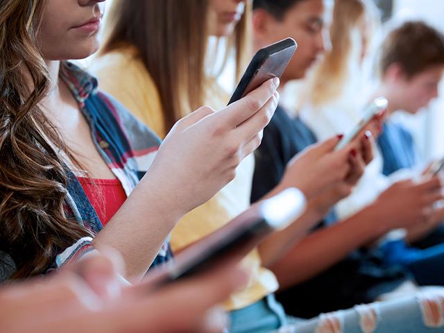 teens on cellphones (Adobe stock)