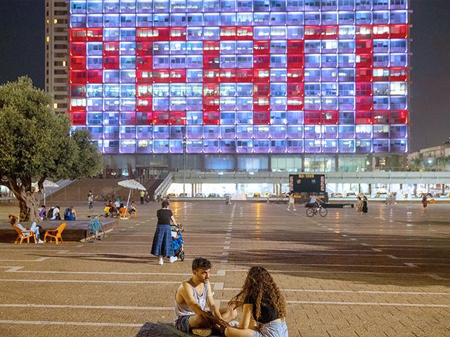 Tel Aviv City Hall is lit up with the words for peace in Hebrew, Arabic and English in honor of the recognition agreements Israel signed with the UAE and Bahrain at the White House, in Tel Aviv, Israel. (AP Photo/Oded Balilty)
