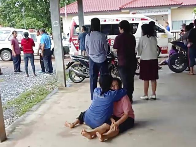 A distraught woman is comforted outside the site of an attack at a daycare center, Oct. 6, 2022, in Nongbua Lamphu, north eastern Thailand.  (Mungkorn Sriboonreung Rescue Group via AP)