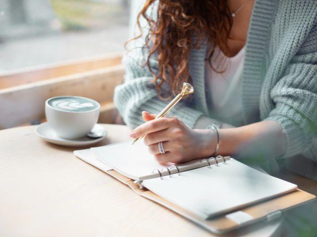 woman writing in journal 