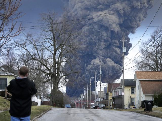 A black plume rises over East Palestine, Ohio, as a result of a controlled detonation of a portion of the derailed Norfolk Southern trains Feb. 6, 2023. (AP Photo/Gene J. Puskar)