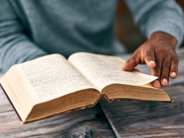 man reading a vintage Bible