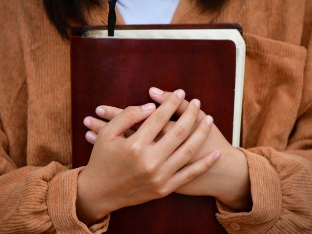 holding bible to chest