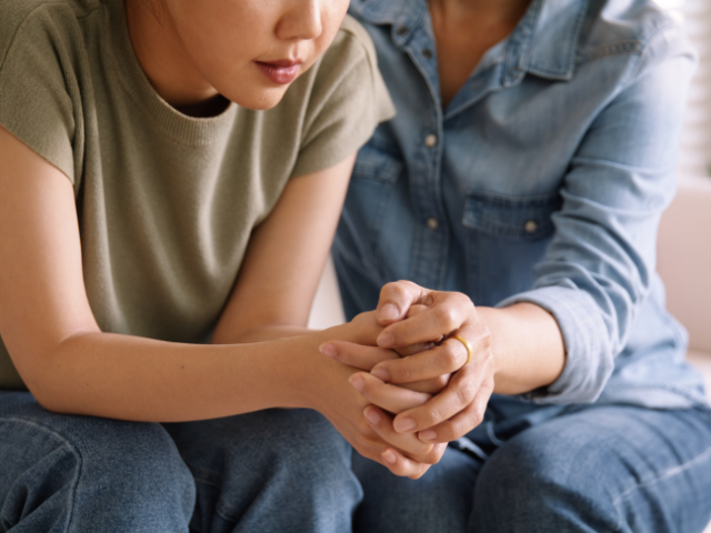 woman consoling another woman