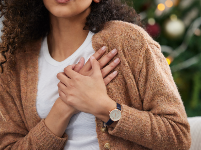 woman with her hands over her heart