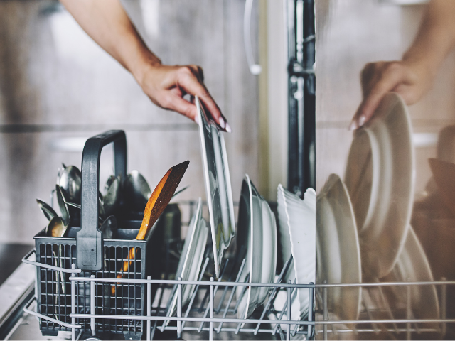 woman loading a dishwasher