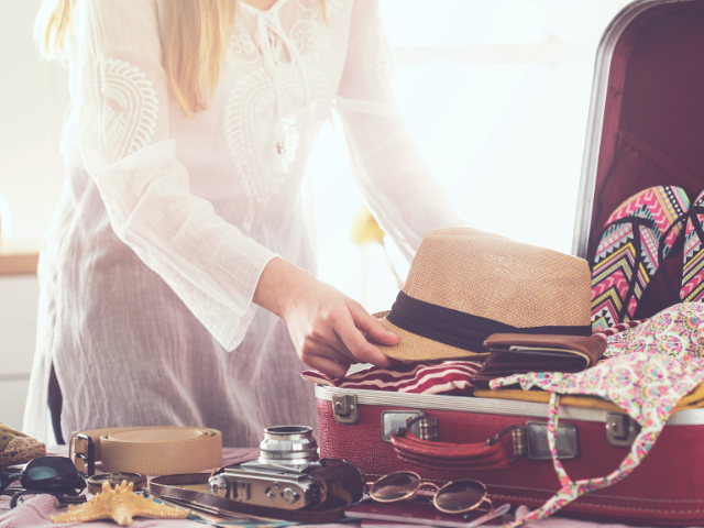 woman packing a suitcase for travel