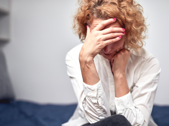 unhappy woman with head in her hand