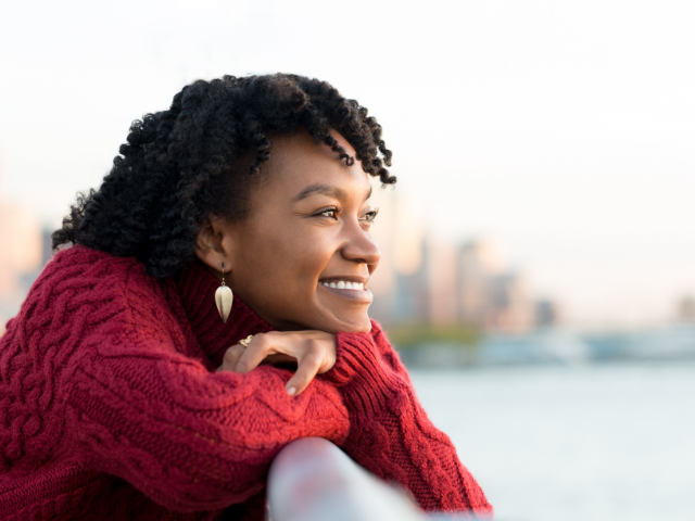 woman wearing a red sweater and smiling