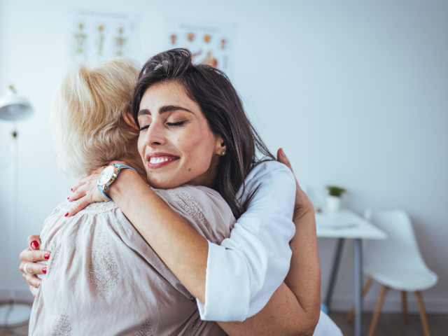 Women hugging with smiles