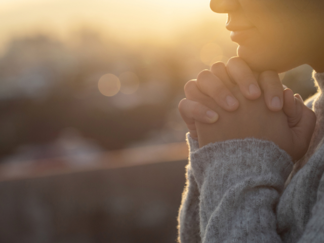 closeup of young adult praying