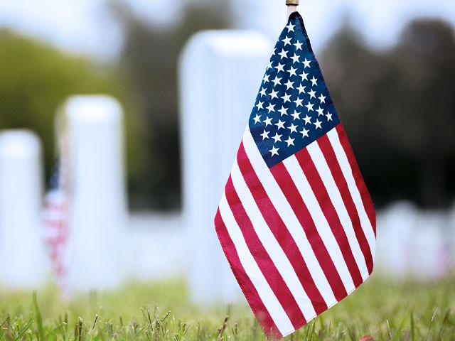 American flags mark gravestones of our fallen troops on Memorial Day (Adobe Stock image)