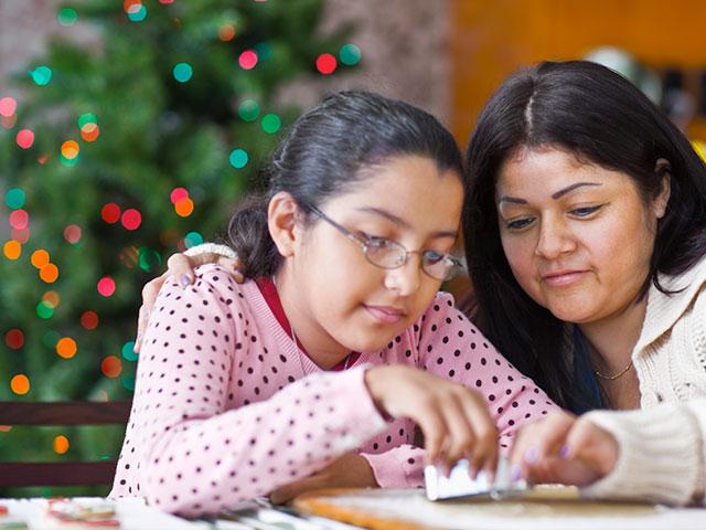 Mother and daughter baking Christmas cookies