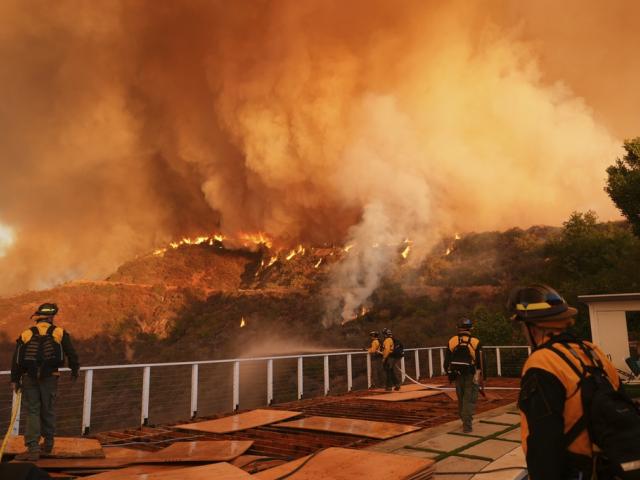 Fire crews monitor the Palisades Fire in Mandeville Canyon on Jan. 11, 2025, in Los Angeles. (AP Photo/Jae C. Hong)