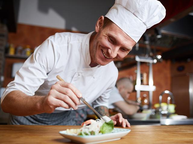 professional chef preparing a plate of food