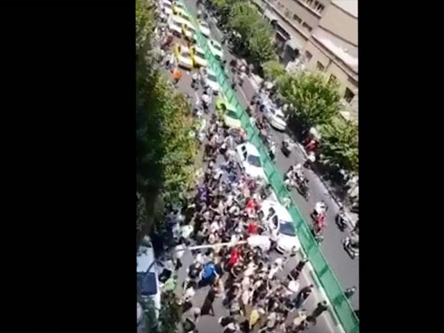 Dozens of demonstrators march down Jomhuri Islami Avenue amid protests over water shortages. (AP video)