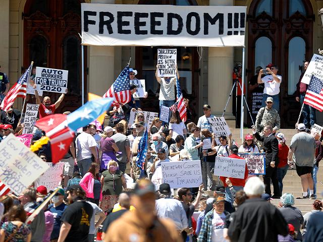 People protest at the State Capitol during a rally in Lansing, Mich., May 20, 2020. Barbers and hair stylists are protesting the state&#039;s stay-at-home orders as small businesses are eager to reopen (AP Photo/Paul Sancya)