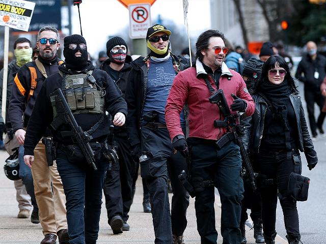 Gun rights supporters walk down Ninth Street in Richmond, Va., on Lobby Day Monday, Jan. 18, 2020. (Alexa Welch Edlund/Richmond Times-Dispatch via AP)