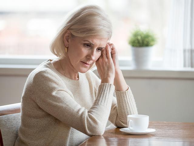 senior woman having coffee alone 