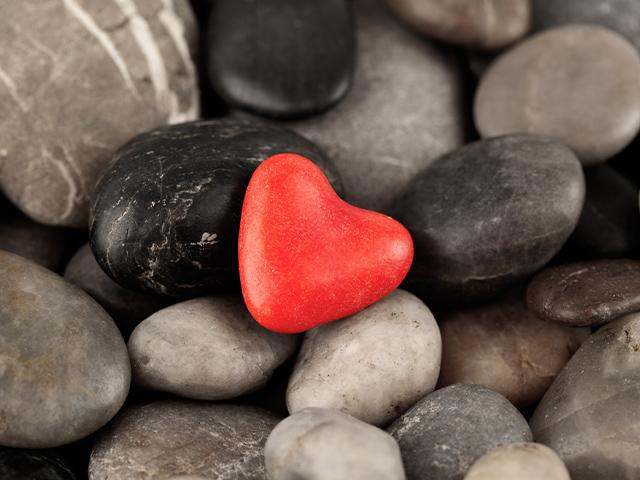 pile of stones with a red heart stone in the middle