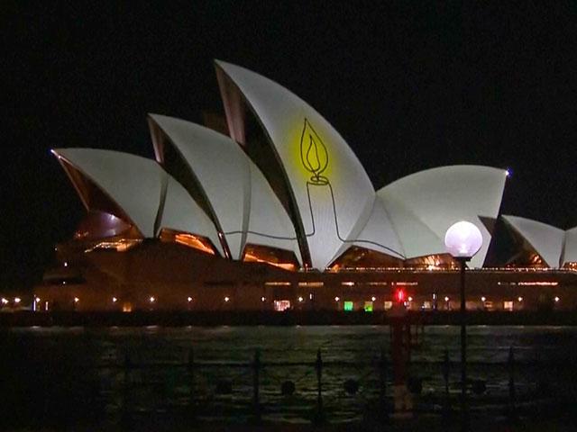 The Sydney Opera House is illuminated with a candle as Australia marks a day of reflection in Bondi following the Hanukkah terror attack. Dec. 21, 2025. Photo credit: Screenshot, Australian Parliament TV/AP.