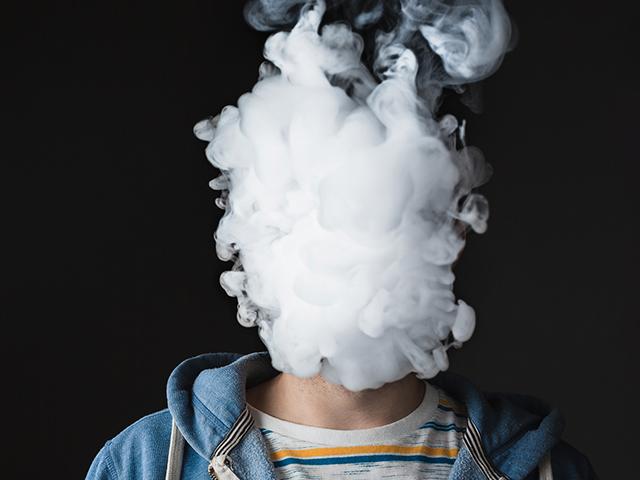 Young man vaping, juuling