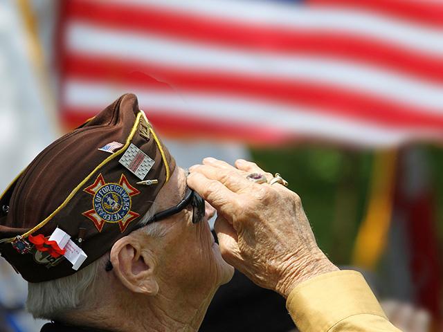 Veteran saluting American flag