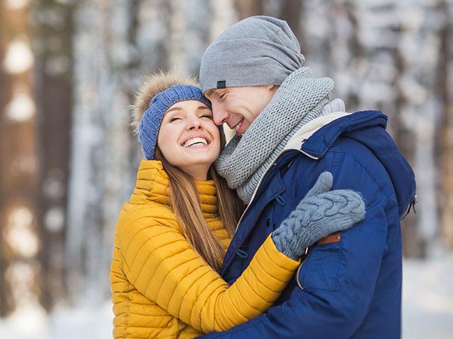 young couple embracing outside in winter