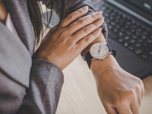 woman checking watch on her arm