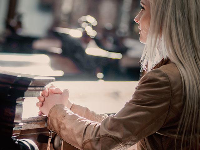 Woman praying in church 
