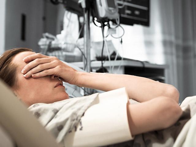 worried woman in a hospital bed