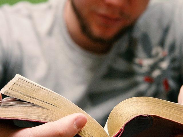 young man holding bible