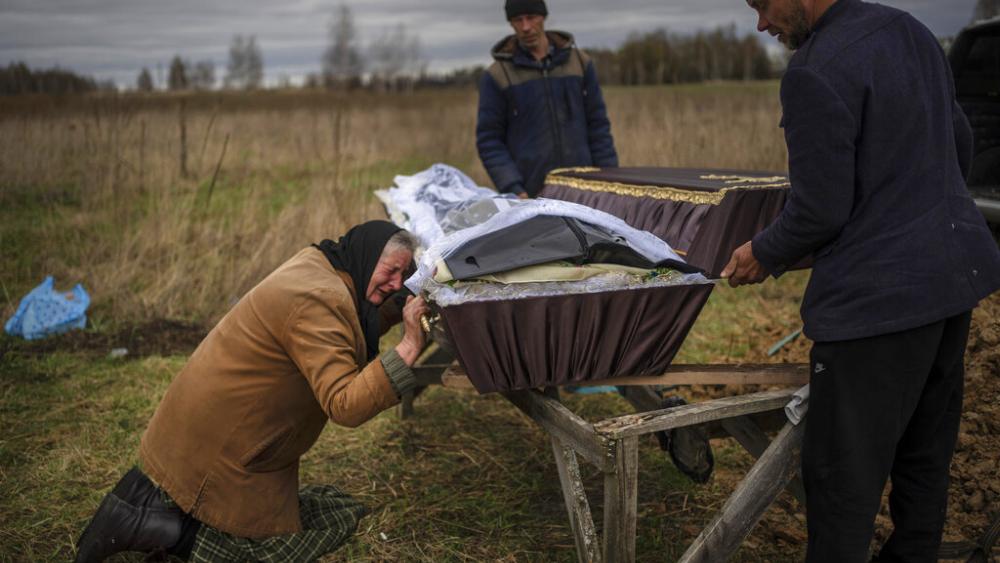 Nadiya Trubchaninova cries over the coffin of her son, Vadym, who was killed on March 30 by Russian soldiers in Bucha, Ukraine, during his funeral in the cemetery of nearby Mykulychi, on the outskirts of Kyiv, on April 16, 2022. 