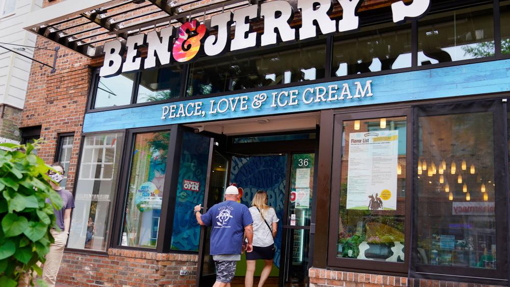 Two patrons enter the Ben &amp; Jerry&#039;s Ice Cream shop, Tuesday, July 20, 2021, in Burlington, Vt. (AP Photo/Charles Krupa)