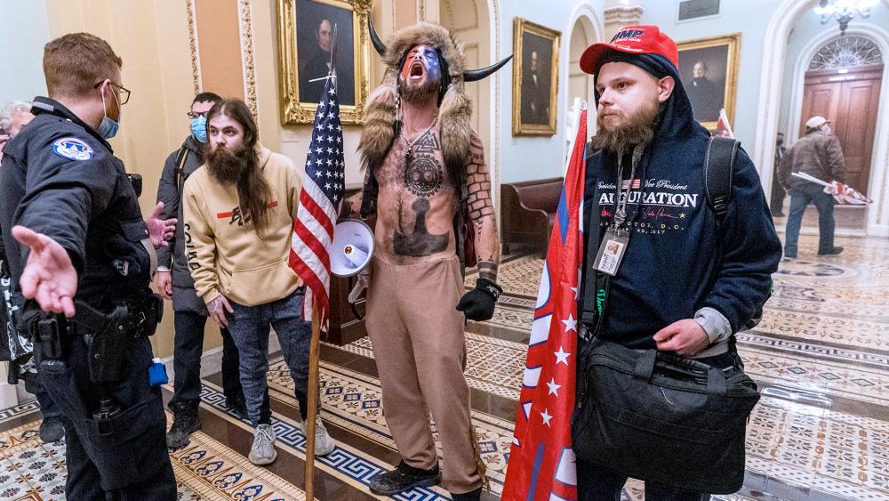 Rioters confronted by Capitol Police officers outside the Senate Chamber inside the Capitol, Wednesday, Jan. 6, 2021. (AP Photo/Manuel Balce Ceneta)