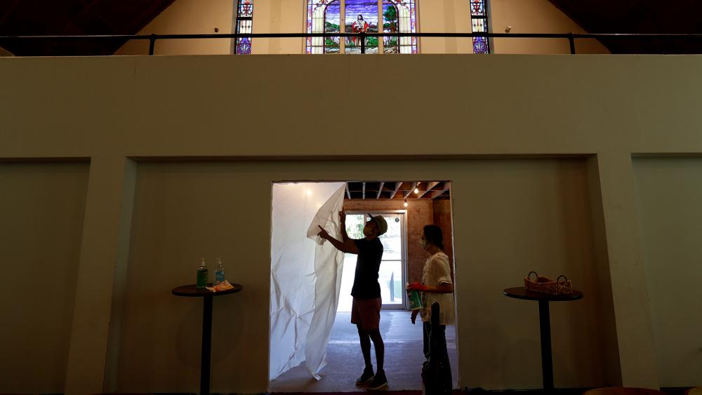 Alamo Heights Baptist Church pastor Bobby Contreras and his wife Hannah work to clean, sanitize and prepare the church for services in San Antonio, May 6, 2020. (AP Photo/Eric Gay)