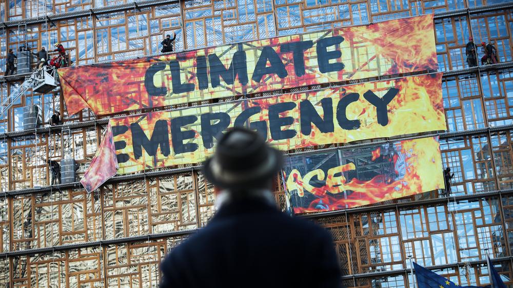 Greenpeace activists scaled the European Union&#039;s new headquarters, unfurling a huge banner warning of a climate emergency in 2019. (AP Photo/Francisco Seco)