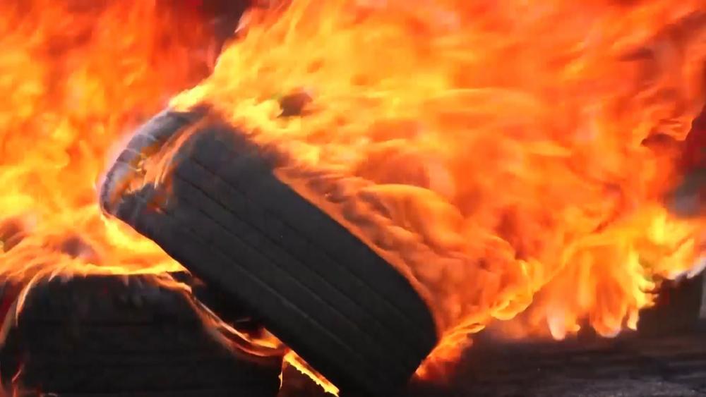 Setting tires on fire, Photo, CBN News